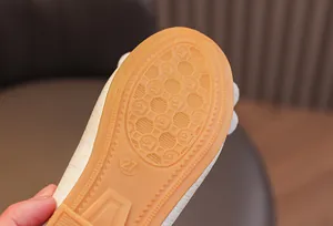 Close-up of non-slip rubber sole with honeycomb texture and size 27 on children's shoes