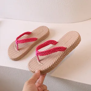 Pink woven strap flip flops for kids with beige non-slip soles for summer beach wear