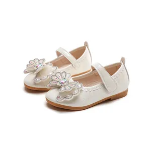Iridescent white Mary Jane shoes for girls featuring rhinestone flower and lace details