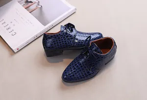 Detail view of boys dark blue crocodile embossed leather dress shoes with oxford laces