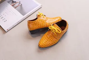 Top view of boys' yellow crocodile embossed patent leather dress shoes with laces