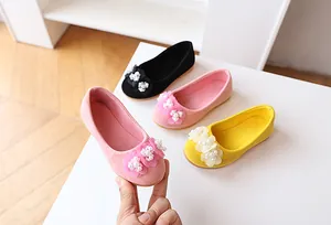 Detail of girl's suede princess shoes featuring three 3D flowers with white pearls