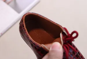 Close-up of red crocodile pattern leather dress shoes with soft inner lining details