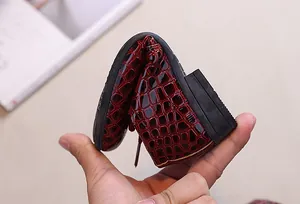 Detail view showing the extreme flexibility and soft crocodile texture of boys dress shoes