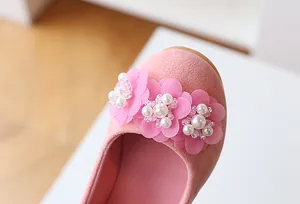 Detail view of pink suede girls princess shoes with delicate mesh flowers and pearl beads