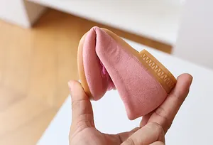 Close-up of flexible pink suede toddler shoe showing 360-degree bendable rubber sole