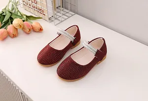 Close-up of deep red glitter Mary Jane shoes for girls featuring double pearl straps