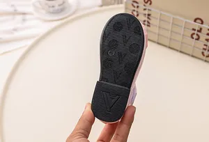 Detail of pink girls' princess shoes showing non-slip rubber sole and size 25 marking