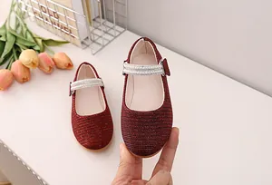 Detail of red glitter Mary Jane shoes for girls featuring double-row pearl strap accents