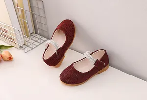 Detail of red glitter Mary Jane shoes for girls featuring elegant pearl strap accents