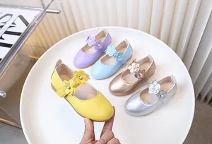 Detail of girls floral Mary Jane shoes in pastel colors with 3D flowers and pearl accents