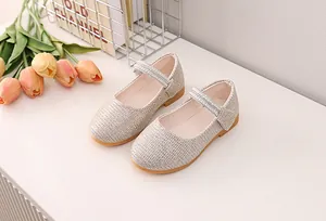 Detail of sparkling champagne sequin girls' Mary Jane shoes with rhinestone straps