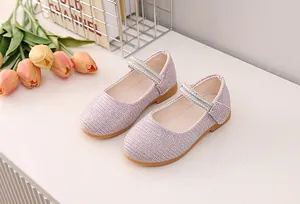 Close-up of pink glitter Mary Jane shoes with double row pearl and rhinestone straps