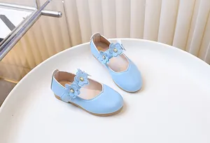 Detail of light blue girls Mary Jane shoes featuring 3D flowers with white pearls