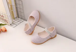 Detailed view of pink Mary Jane shoes with woven texture and pearl strap decoration