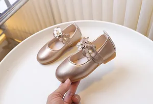 Detail of flower Mary Jane shoes for girls with pearl accents and champagne gold leather