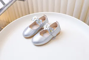 Detailed view of silver girls Mary Jane shoes with floral accents and pearl details