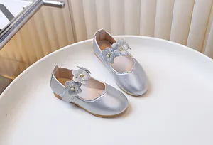 Detail of silver Mary Jane girl shoes with 3D flower, pearl inlay, and velcro strap