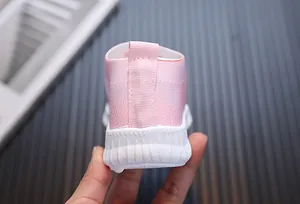 Détail de la basket en maille rose pour fille avec tissu respirant et semelle blanche