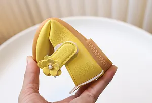 Flexible yellow girls princess shoe with leather flower and soft rubber sole folded