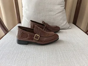 British style brown loafers for boys featuring crocodile texture and gold buckle detail