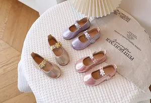 Close-up of sparkling Mary Jane flats for girls in purple, champagne gold, and pink colors