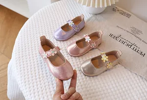 Macro shot of metallic Mary Jane shoes for girls with lace flower details in various colors