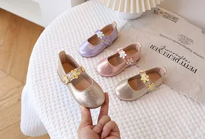 Close-up of metallic Mary Jane shoes for girls featuring three-dimensional flower details