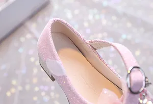 Gros plan sur les chaussures de princesse roses à paillettes avec boucle en métal