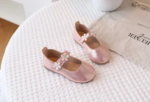 Close-up of pink Mary Jane shoes with delicate lace flowers and non-slip rubber soles