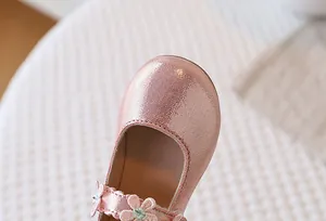 Detail of pink glitter Mary Jane shoes for girls featuring intricate floral embroidery on straps