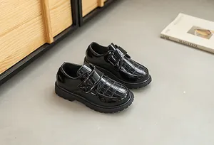 Detail of boys black faux crocodile texture leather shoes with dual velcro straps