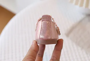 Macro view of pink glitter girl princess shoes with 3D floral decoration on heel
