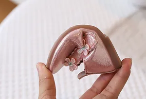 Close-up of flexible soft sole design on rose gold floral princess shoes for girls