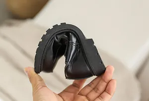Detail showing the ultra-flexible sole and soft leather of black boys dress shoes