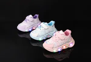 Detail of LED light-up sneakers for girls with glitter finish and sequin butterfly accents