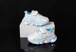 Detail of LED light-up sole on kids sneakers with glitter stars and velcro strap