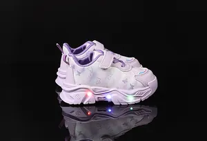 Detailed view of LED light-up sole with purple butterfly patterns on girls sneakers