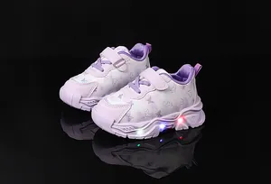 Close-up of girls' purple sneakers with LED light-up soles and butterfly patterns