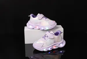 Detail of girls purple LED light-up sneakers with rainbow patterns and velcro strap