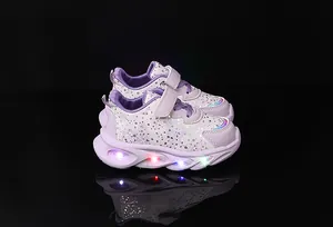 Close-up of girls purple floral sneakers with glowing LED lights and velcro strap
