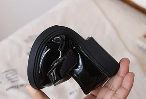 Detail shot of flexible black patent leather girls Mary Jane shoes showing sole softness