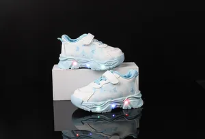 Detail view of girl's blue butterfly sneakers showing magic tape and LED glowing soles