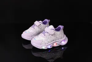 Detail of girls' light-up sneaker showing LED soles and purple polka dot velcro strap