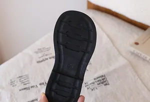 Detail of black non-slip rubber sole with size 28 marking for girls' princess shoes
