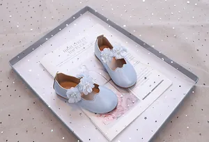 Details von hellblauen Prinzessinnenschuhen für Mädchen mit Pailletten und Perlenblumen