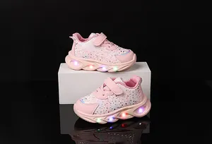 Detail of pink LED light-up sneakers for girls with floral patterns and velcro closure