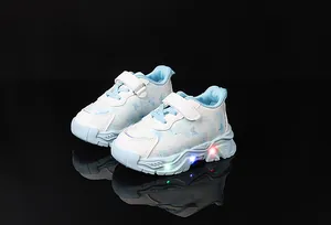 Close-up of girls' light-up shoes featuring LED soles and blue butterfly patterns
