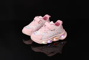 Detail of pink LED light-up sneakers for girls with glitter floral pattern and glowing soles