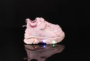 Detailed view of pink toddler sneakers with LED lights and purple butterfly patterns